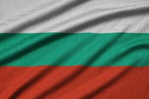 Bulgaria flag is depicted on a sports cloth fabric with many folds. Sport team waving banner